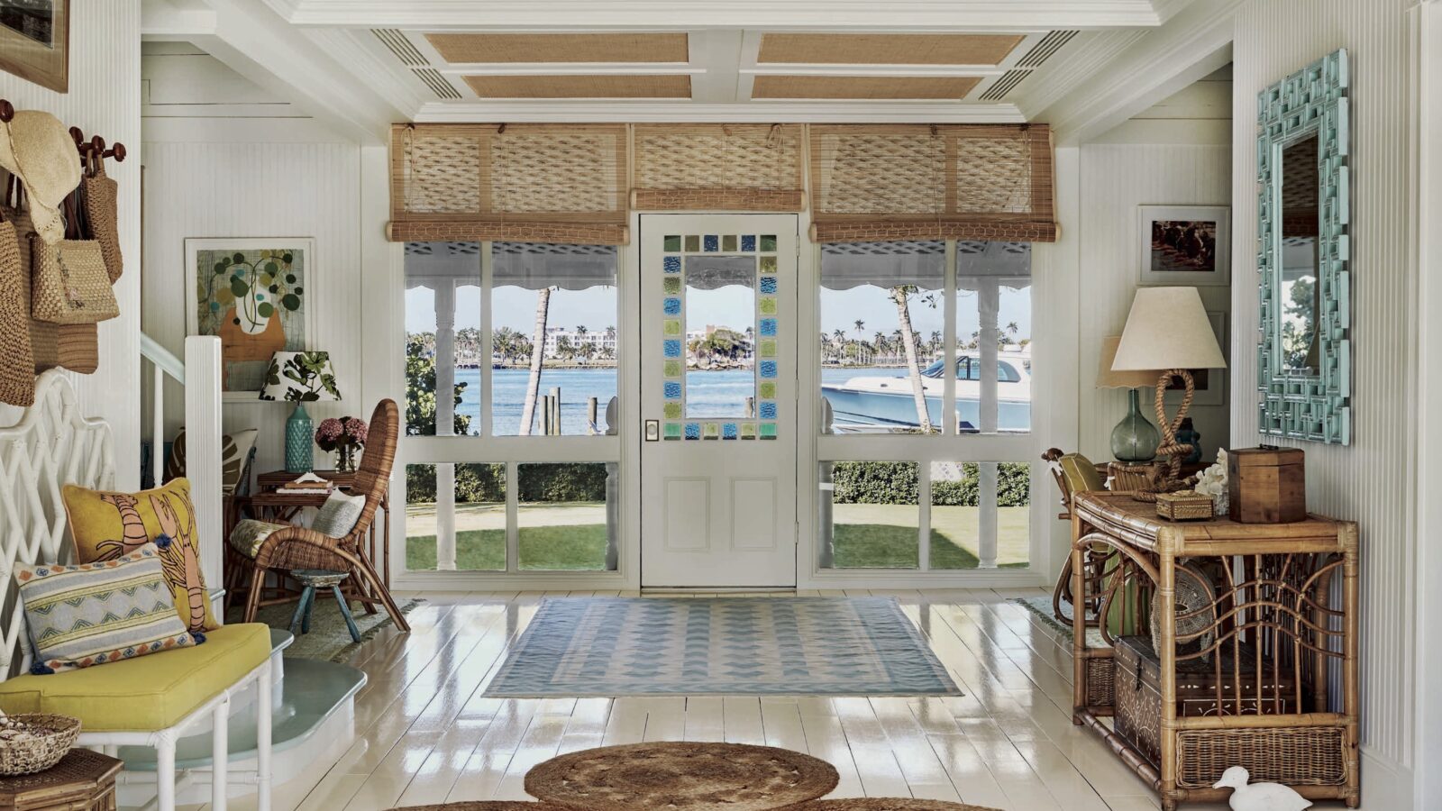 A layered decorated entryway looks to the water