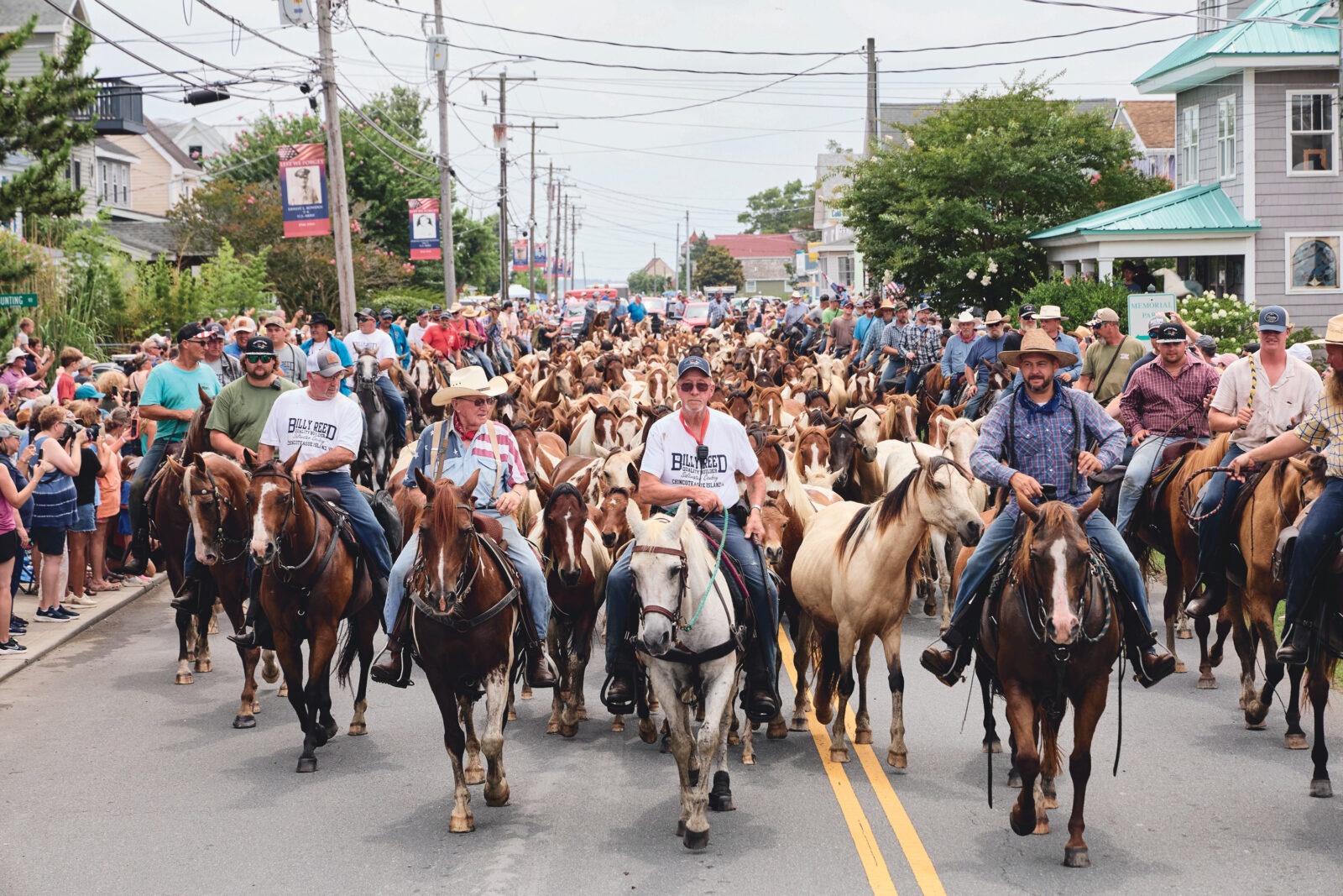 People lead ponies through a town