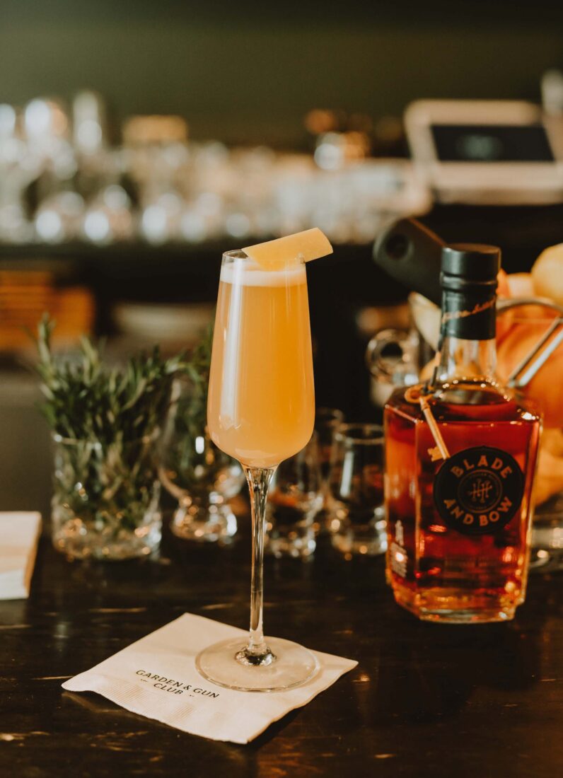 An orange cocktail in a glass