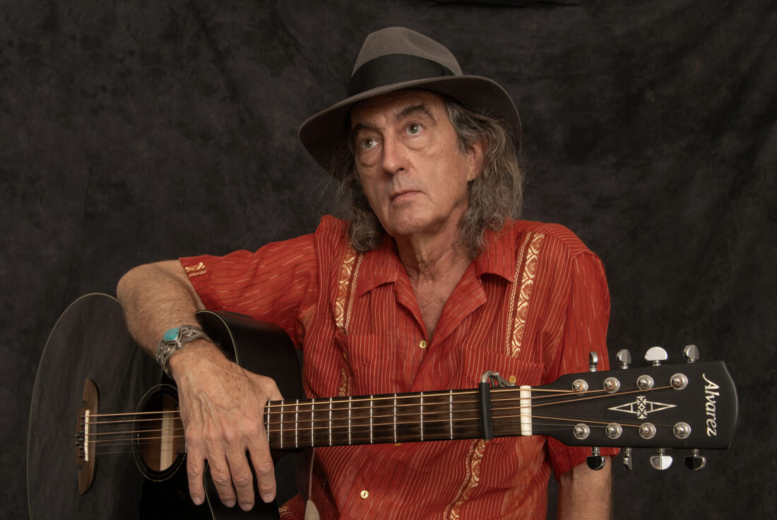 A portrait of a man with a guitar