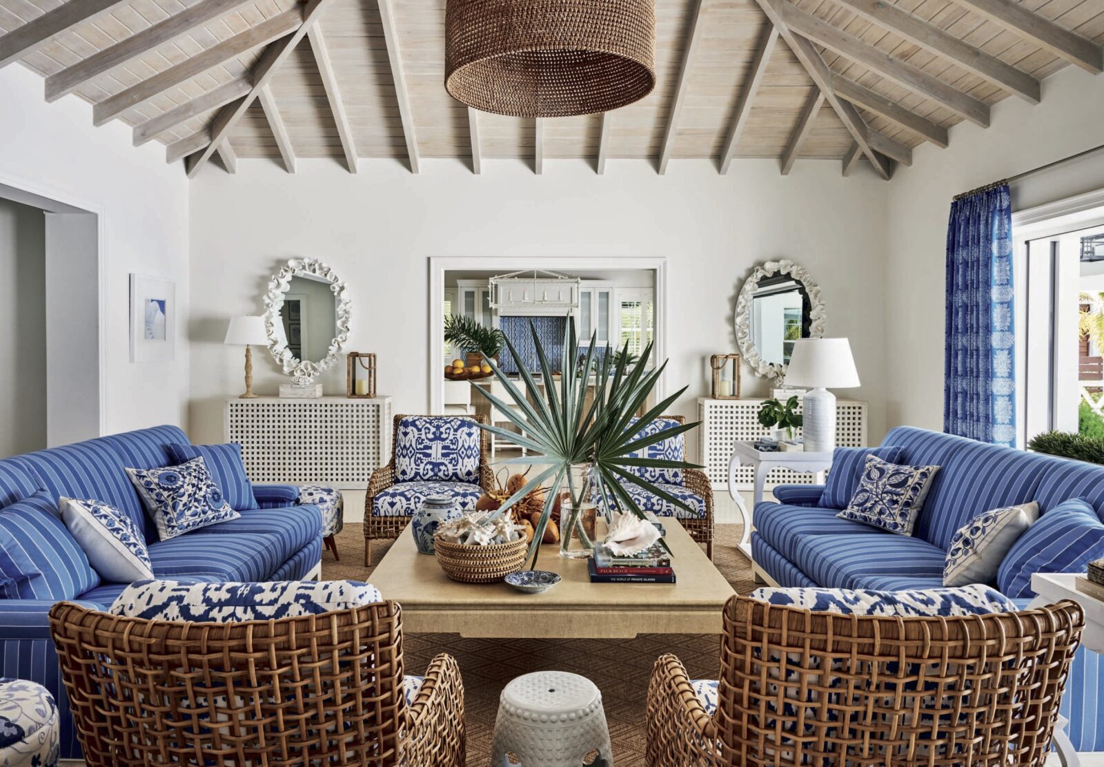 A livingroom with blue and natural fabrics and materials