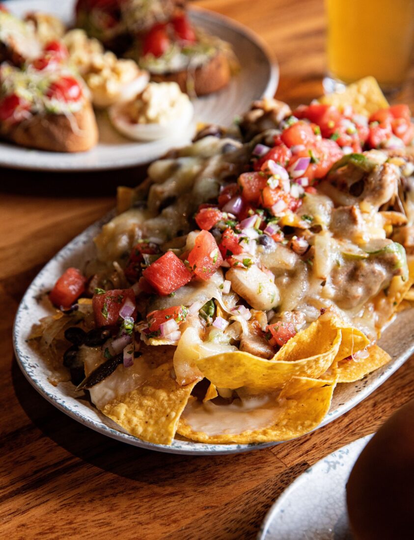 A nacho appetizer topped with watermelon pico de gallo