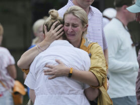 Two women embrace