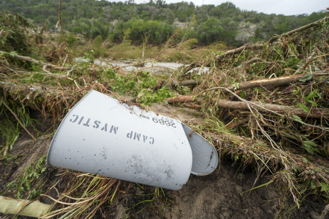 A Camp Mystic mailbox lays in flood debris