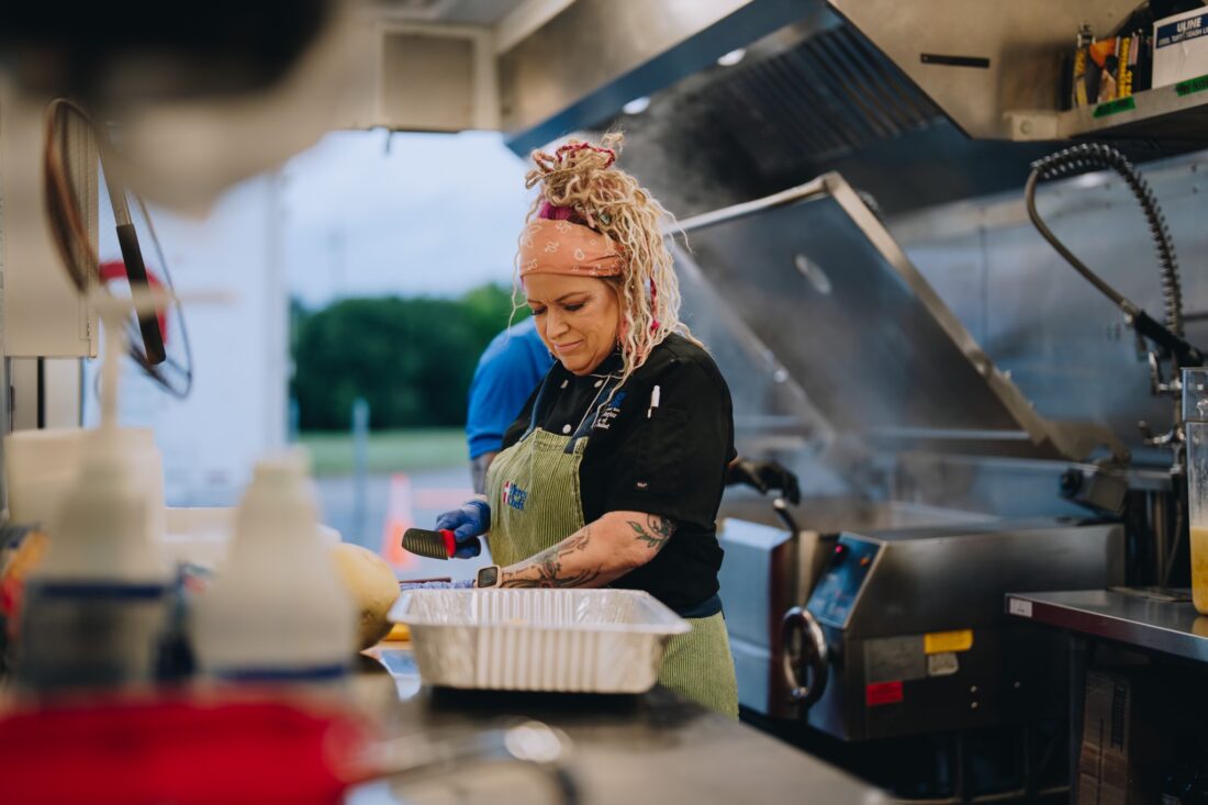 A woman works in a kitchen