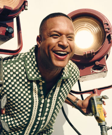 A portrait of Craig Melvin in a green checkered shirt