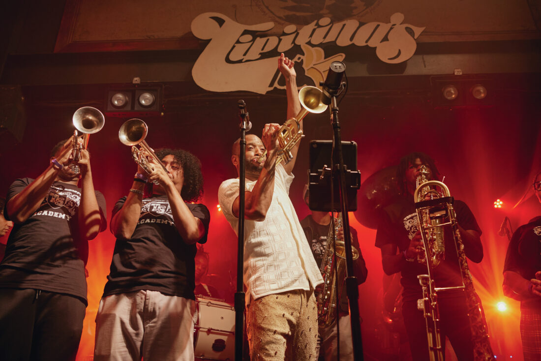 A group of people perform on stage, playing music