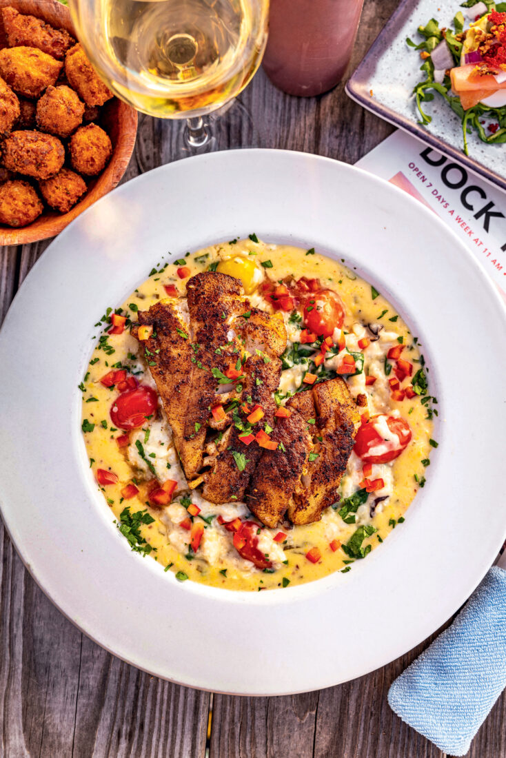 A plate of risotto with triggerfish and a glass of wine