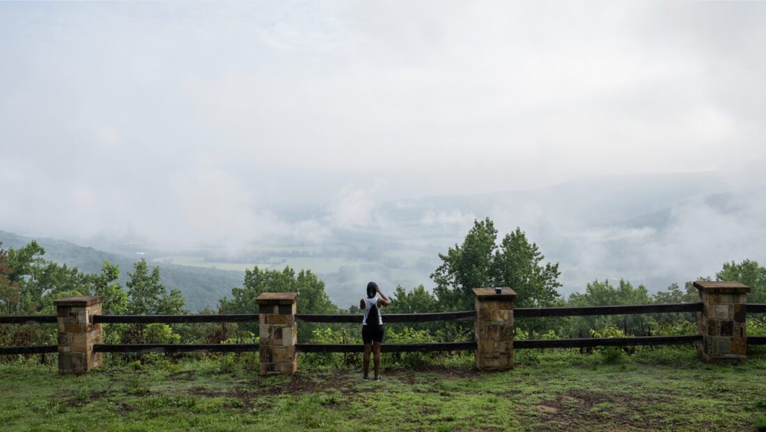 A person looks over a mountainscape