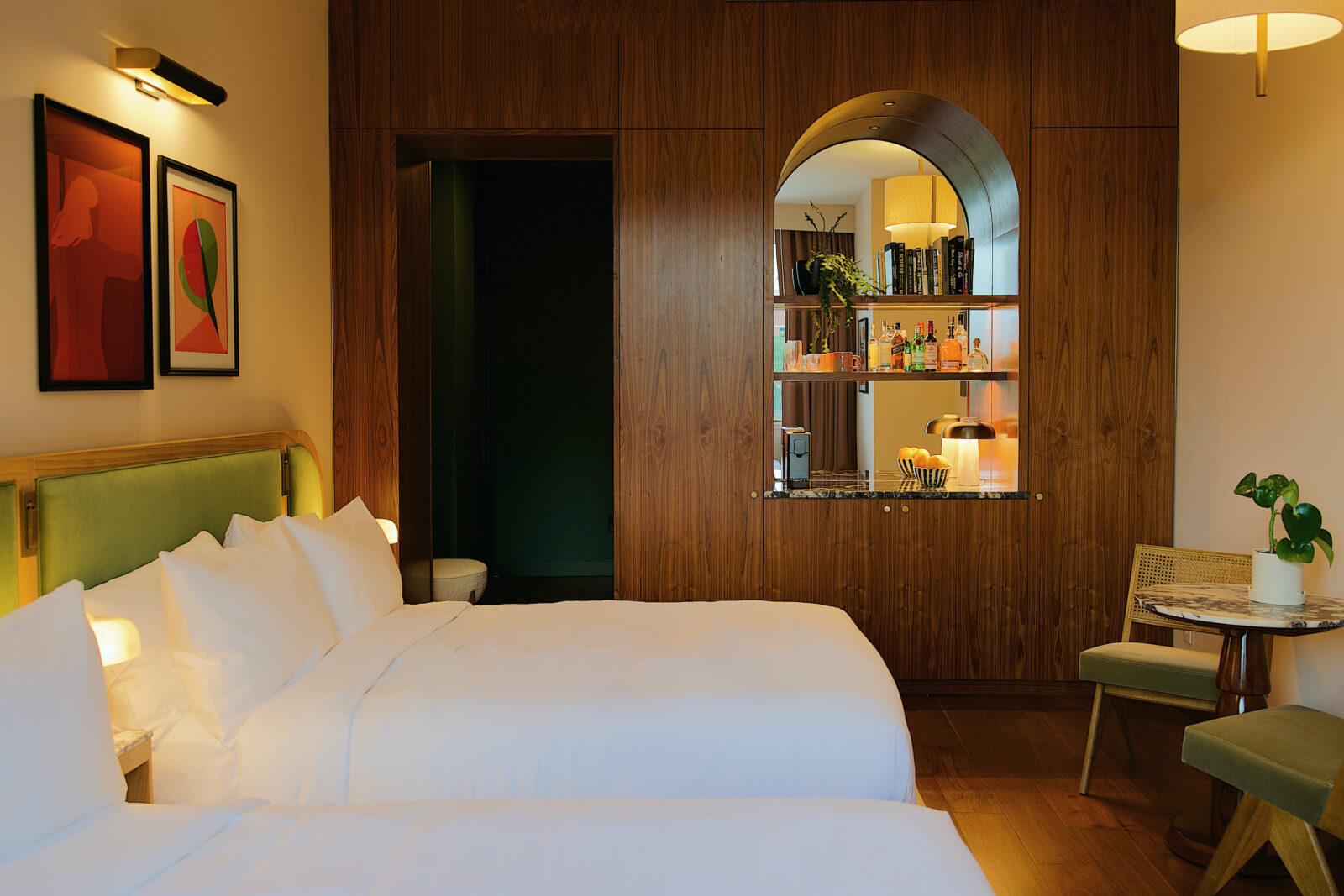 A guest room with a curved wooden bar