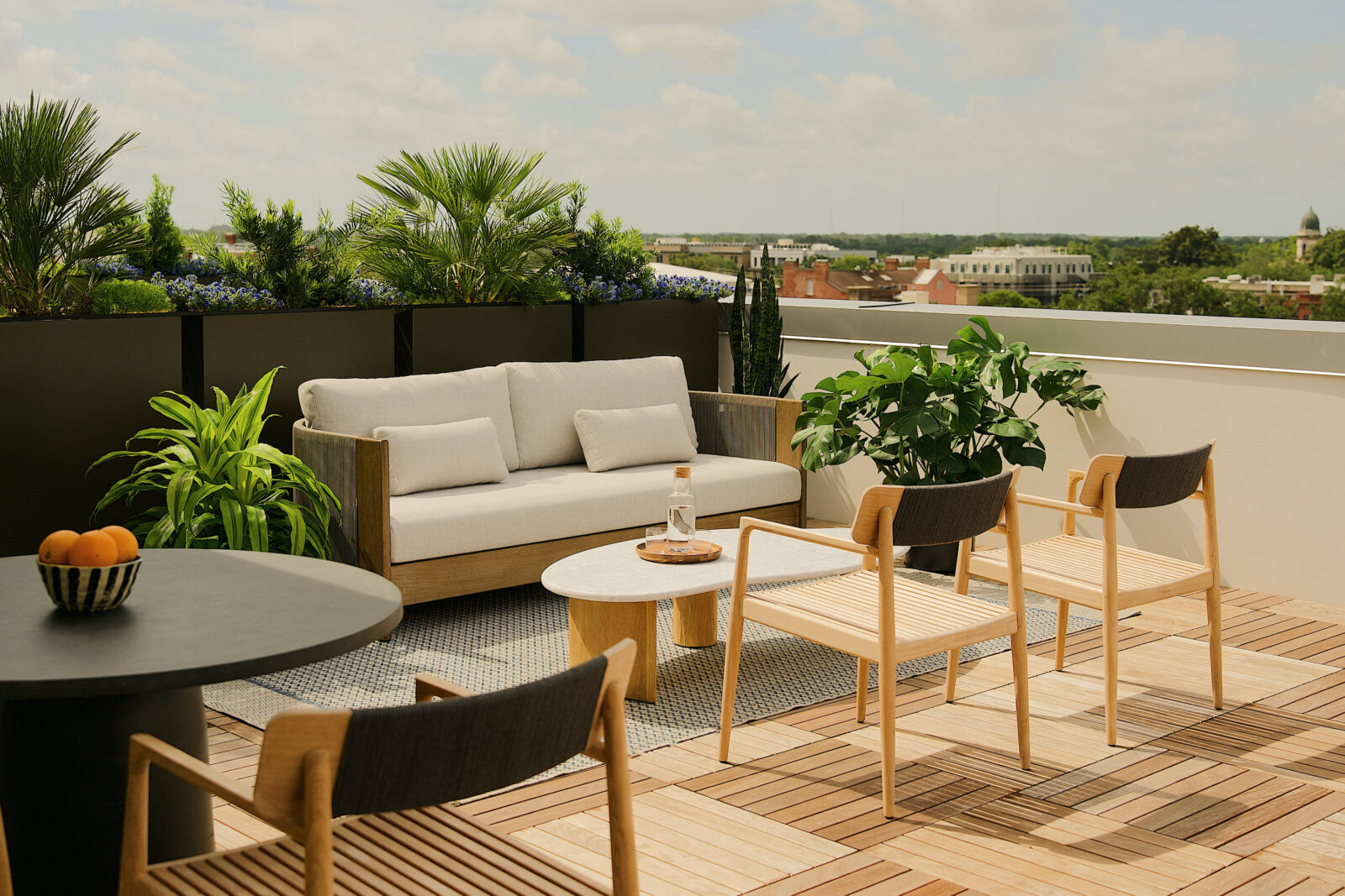 A patio with a white cushioned chair and tables
