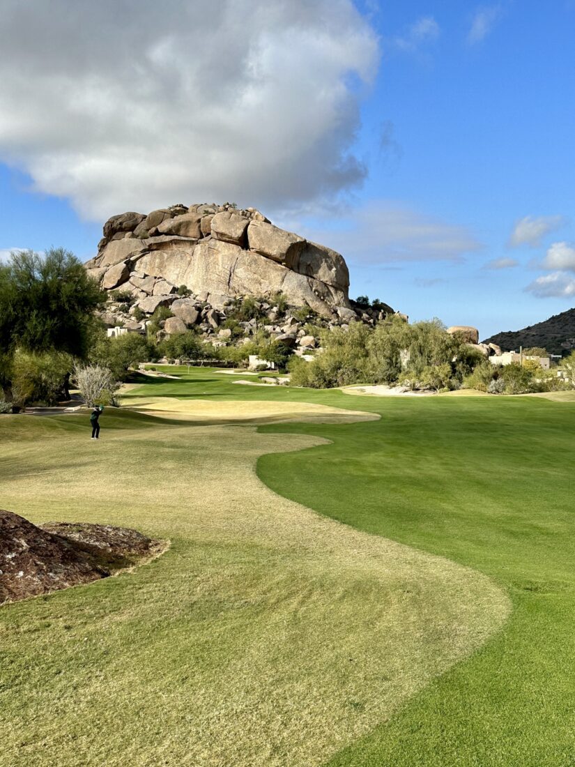 A golf course near a boulder landscape