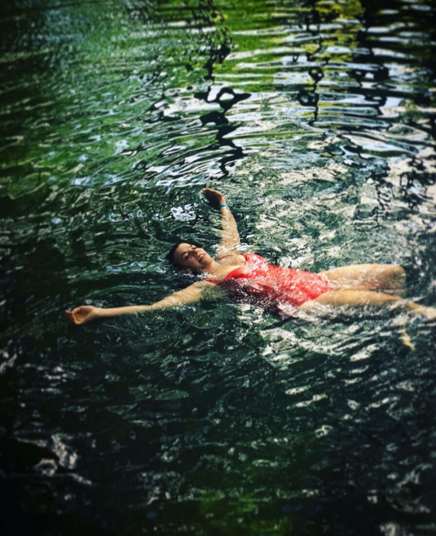 A woman floats in a river