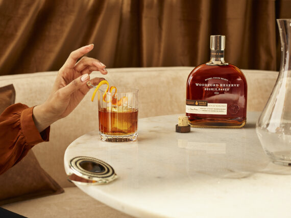 A person drinks an old fashioned cocktail