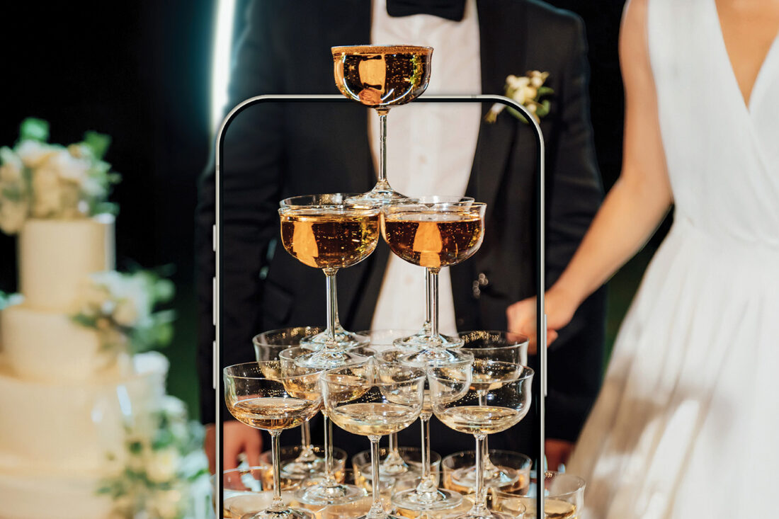 Champagne glasses in front of a bride and groom