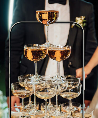 Champagne glasses in front of a bride and groom