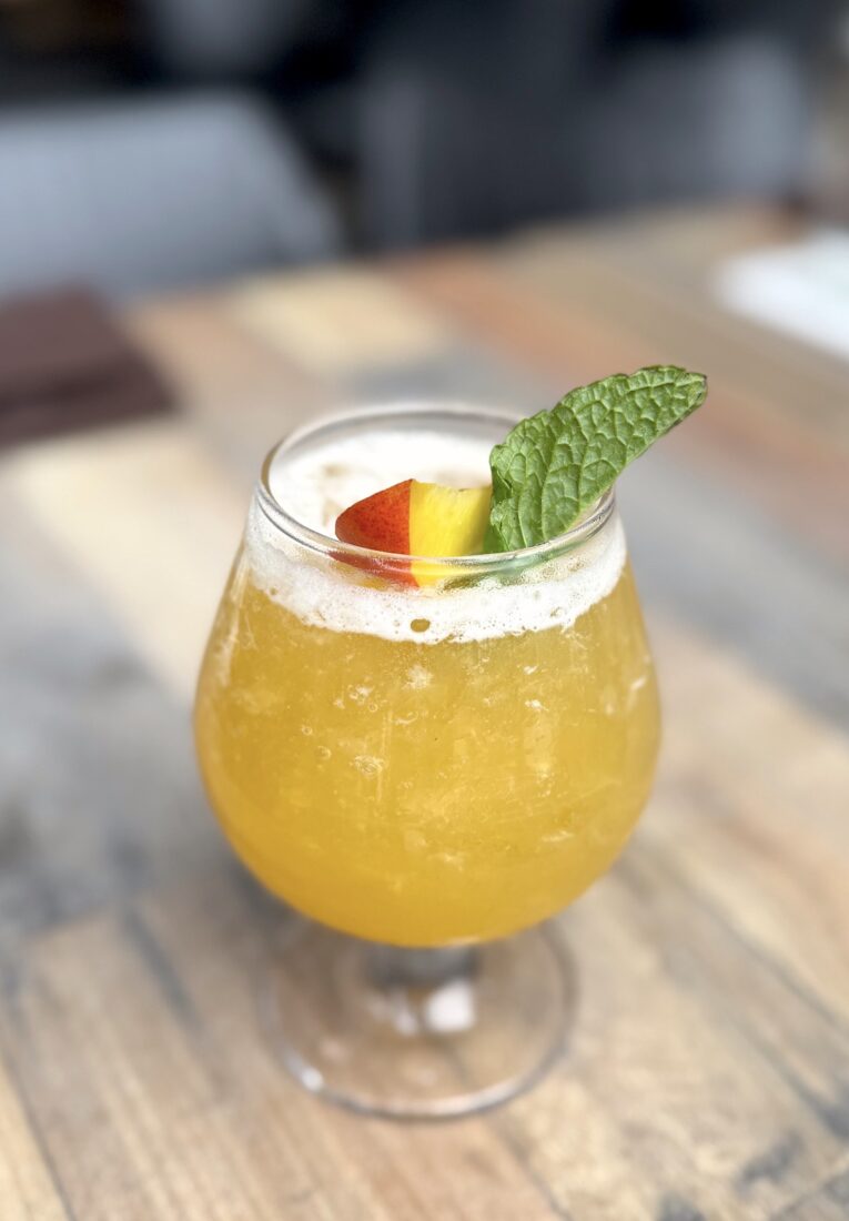 An orange cocktail in a glass