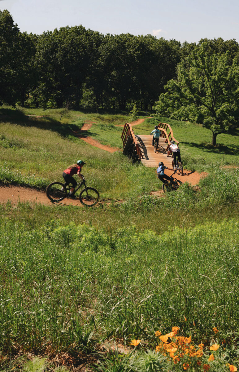 People bike on a trail outdoors