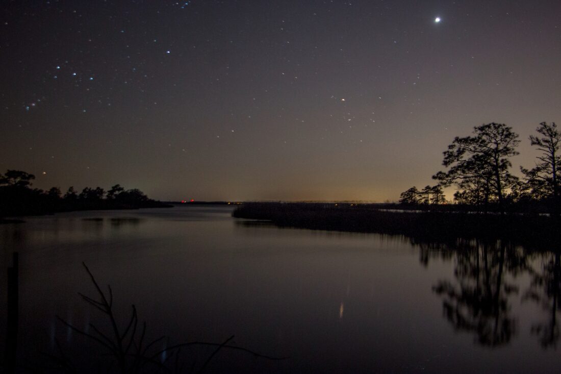 A starry sky over a stretch of water