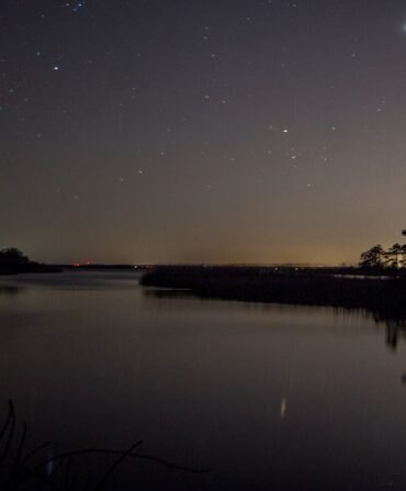 A starry sky over a stretch of water