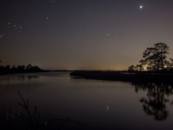 A starry sky over a stretch of water
