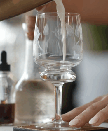 A person pours a milk punch