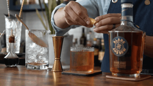 A person makes an old fashioned