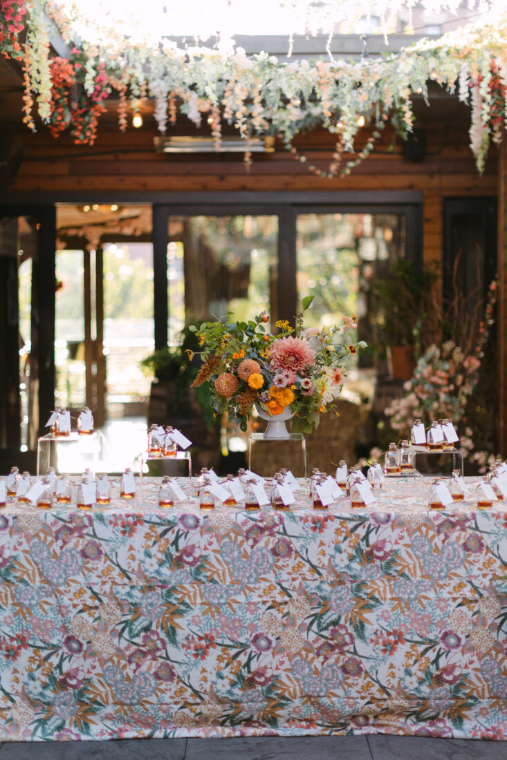 Escort cards tied to mini pours of Old Forester 1920 greet guests upon arrival to Jack Rose.