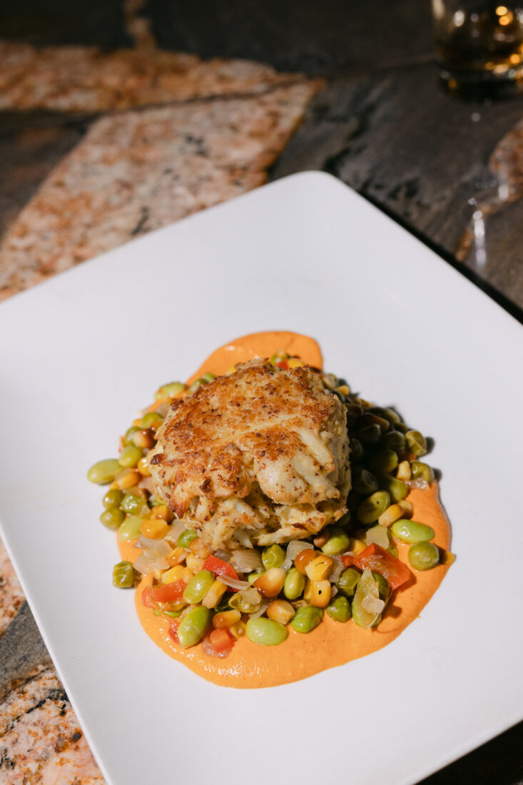 The second course: jumbo lump crab cake with smoked summer succotash and Bourbon Barrel paprika.