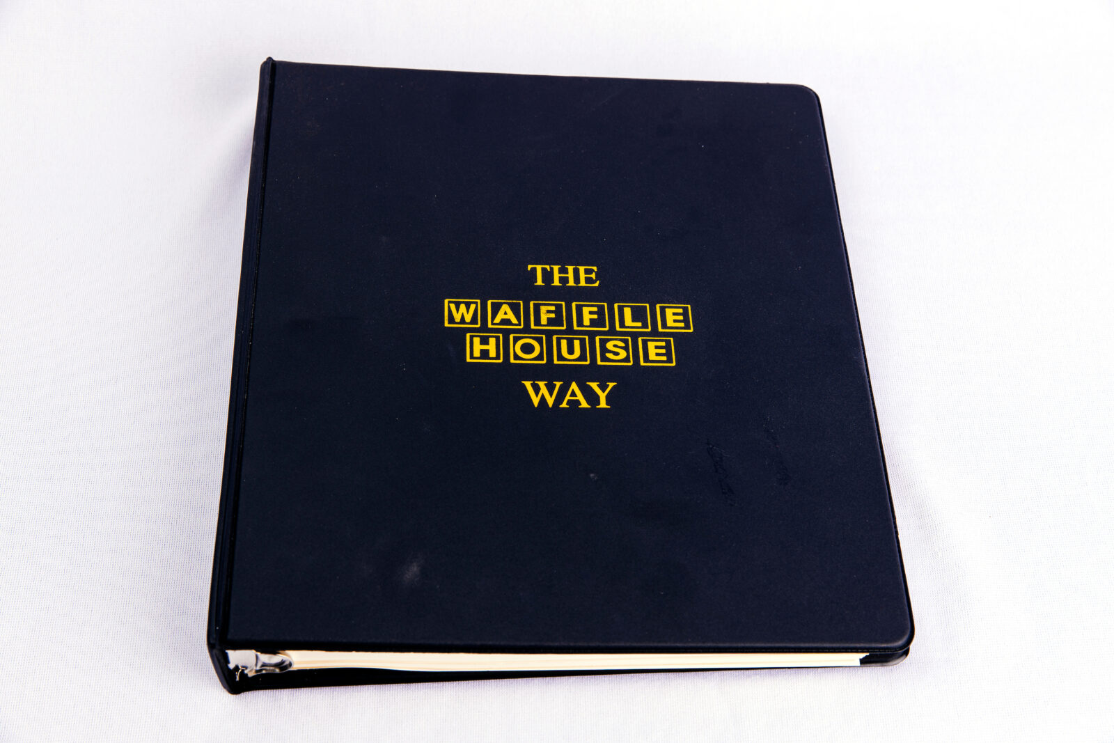 A black book with the "Waffle House Way" on the front