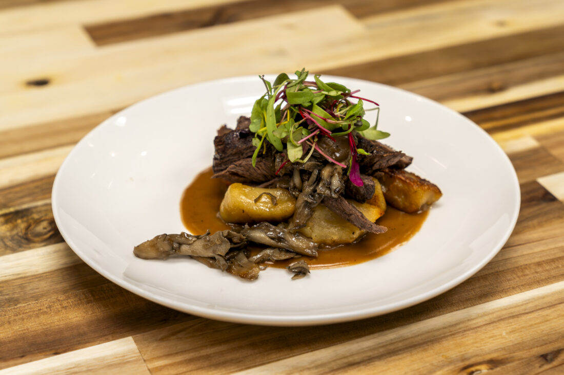 The second course: Grilled hanger steak with potato dumplings, Hen of the Woods mushrooms, shallots, and gravy.