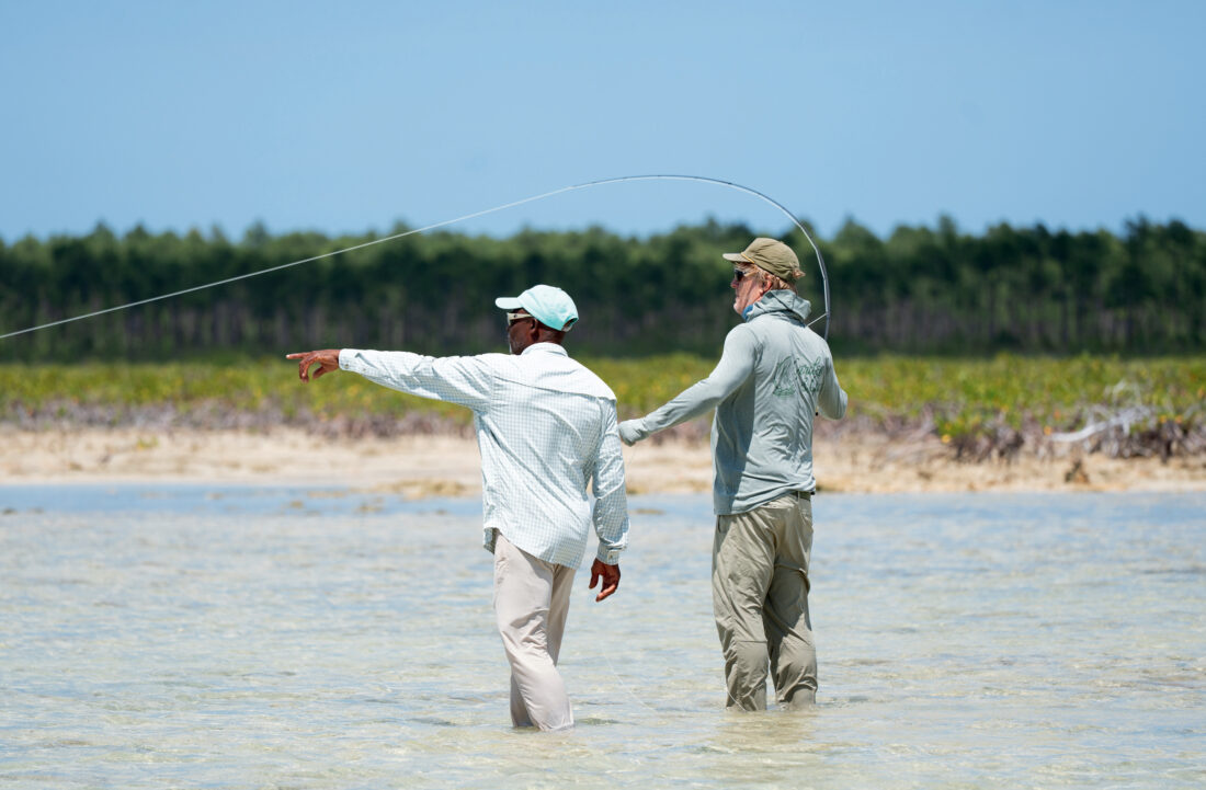 Two men fish in a saltwater flat