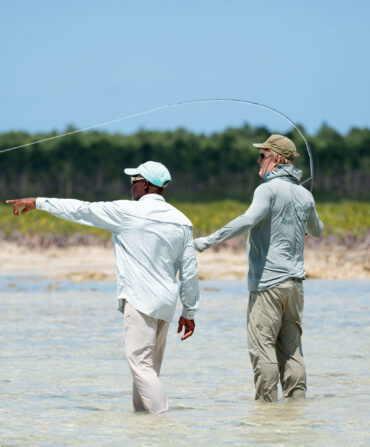 Two men fish in a saltwater flat