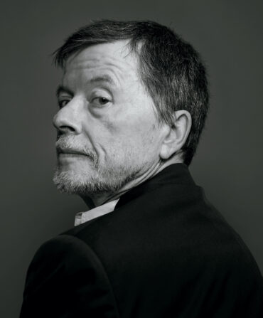 A black and white portrait of Ken Burns