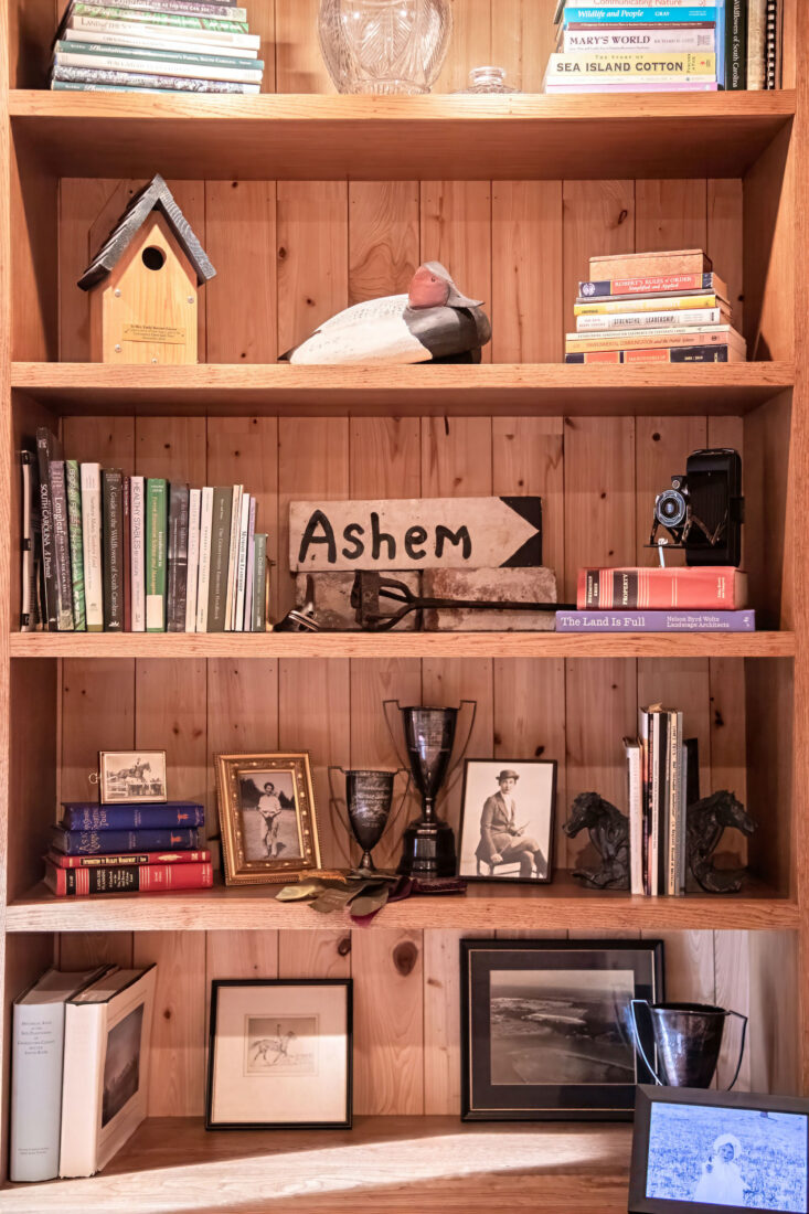 A bookshelf with objects and books