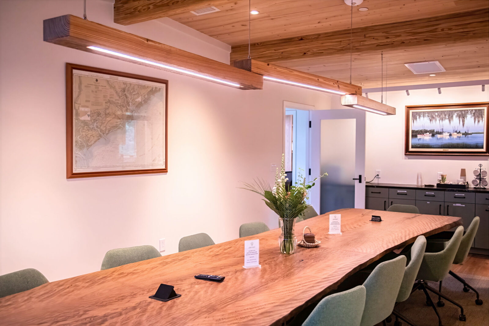 A long wood conference table in a conference room