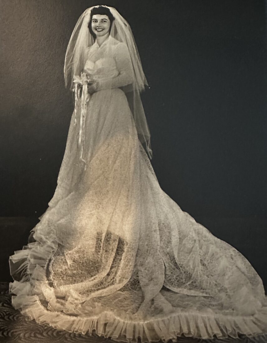 A bride wears a long, elegant white dress