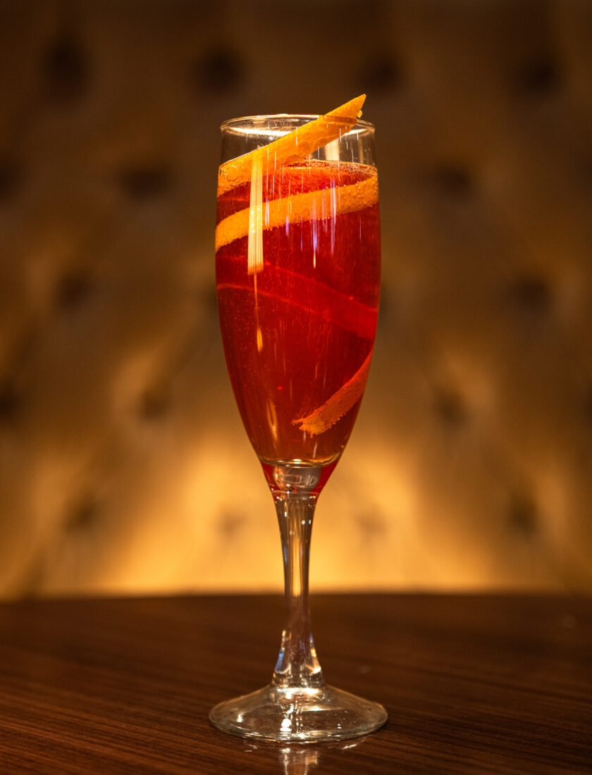 A cocktail in a tall flute glass