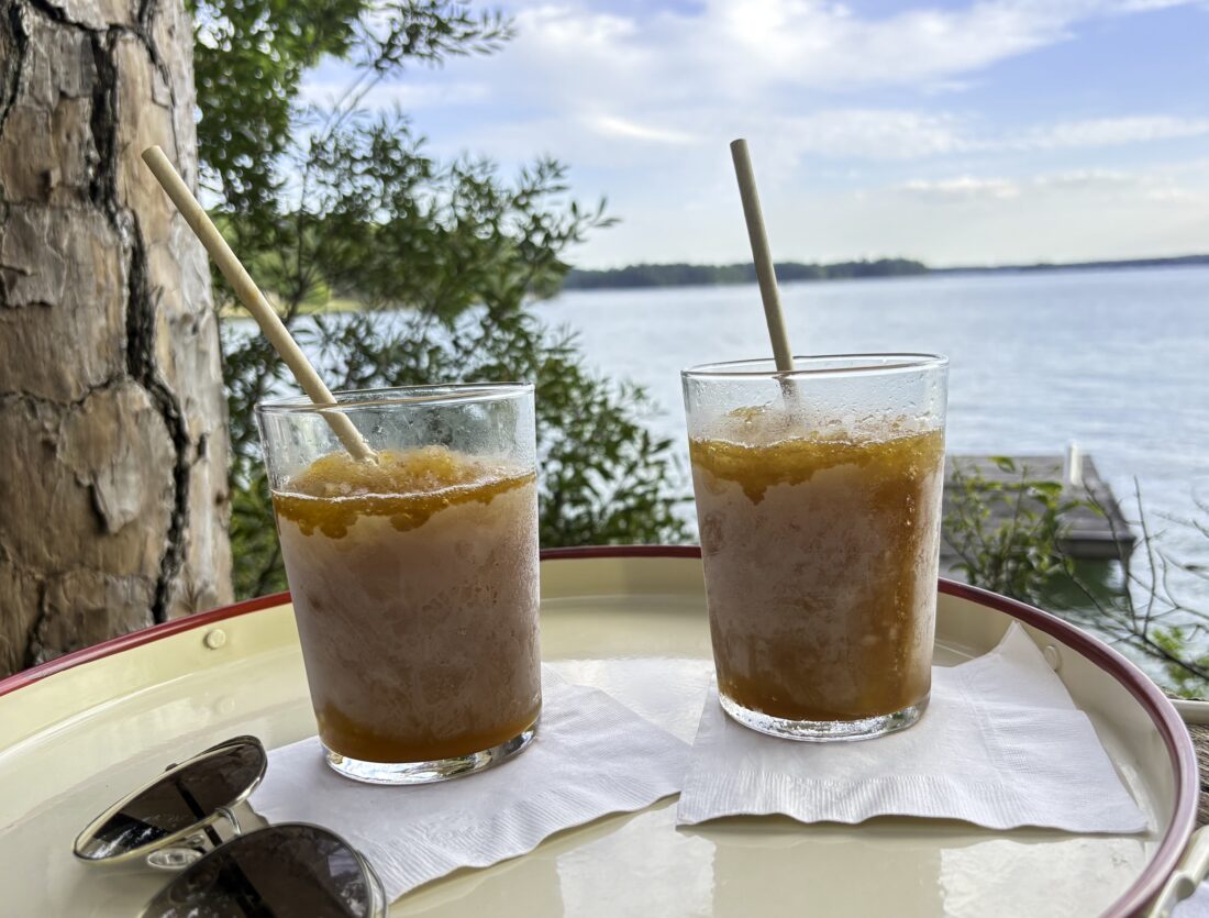 Bourbon slushes on a tray in front of a lake