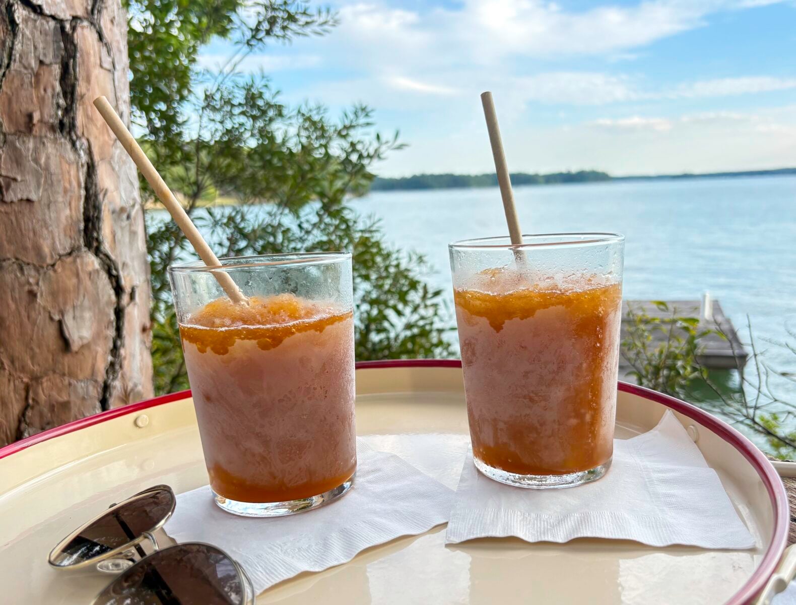 Bourbon slushes on a tray in front of a lake
