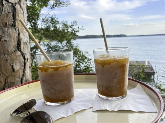 Bourbon slushes on a tray in front of a lake