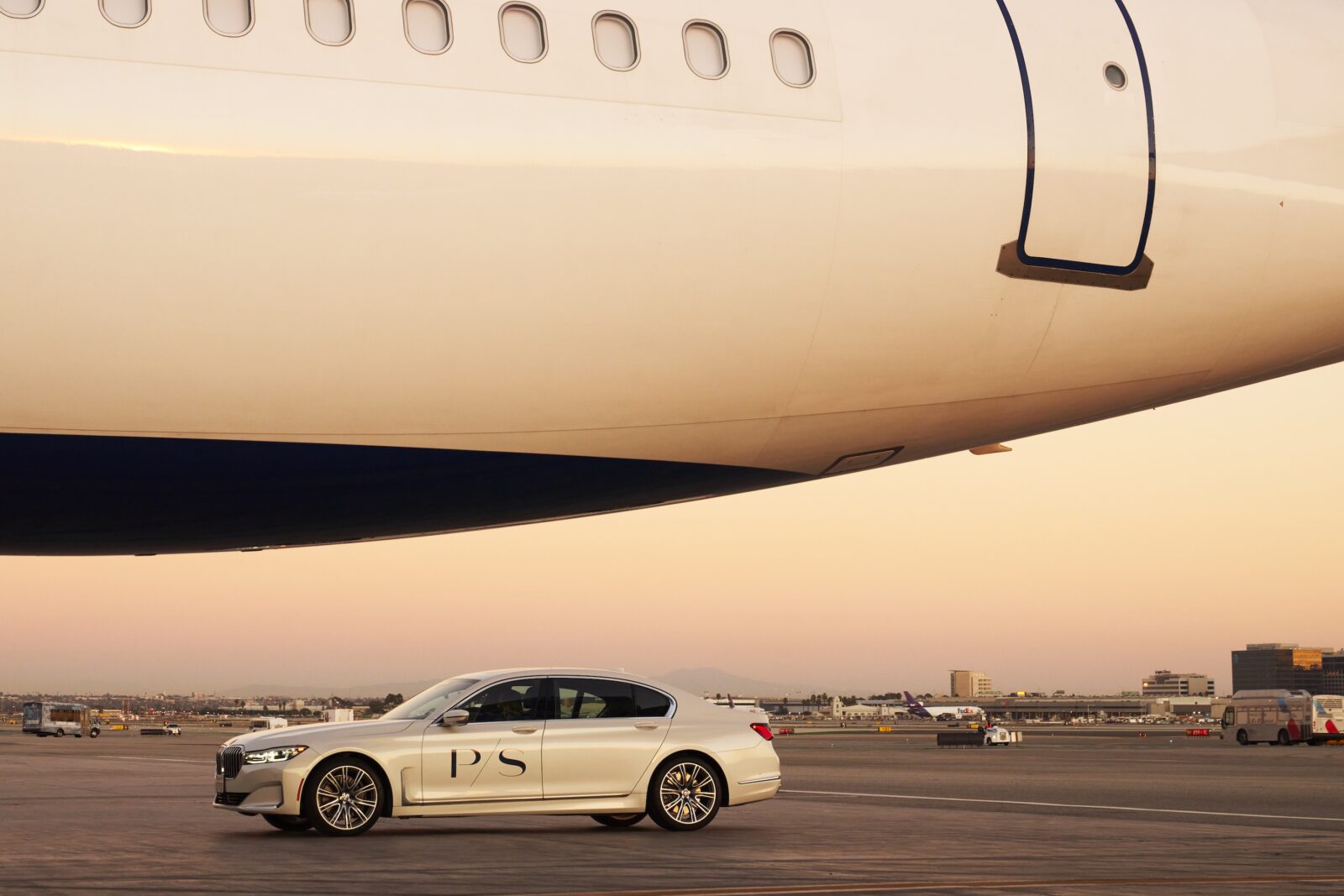 A car parked beside a plane