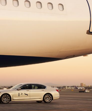 A car parked beside a plane