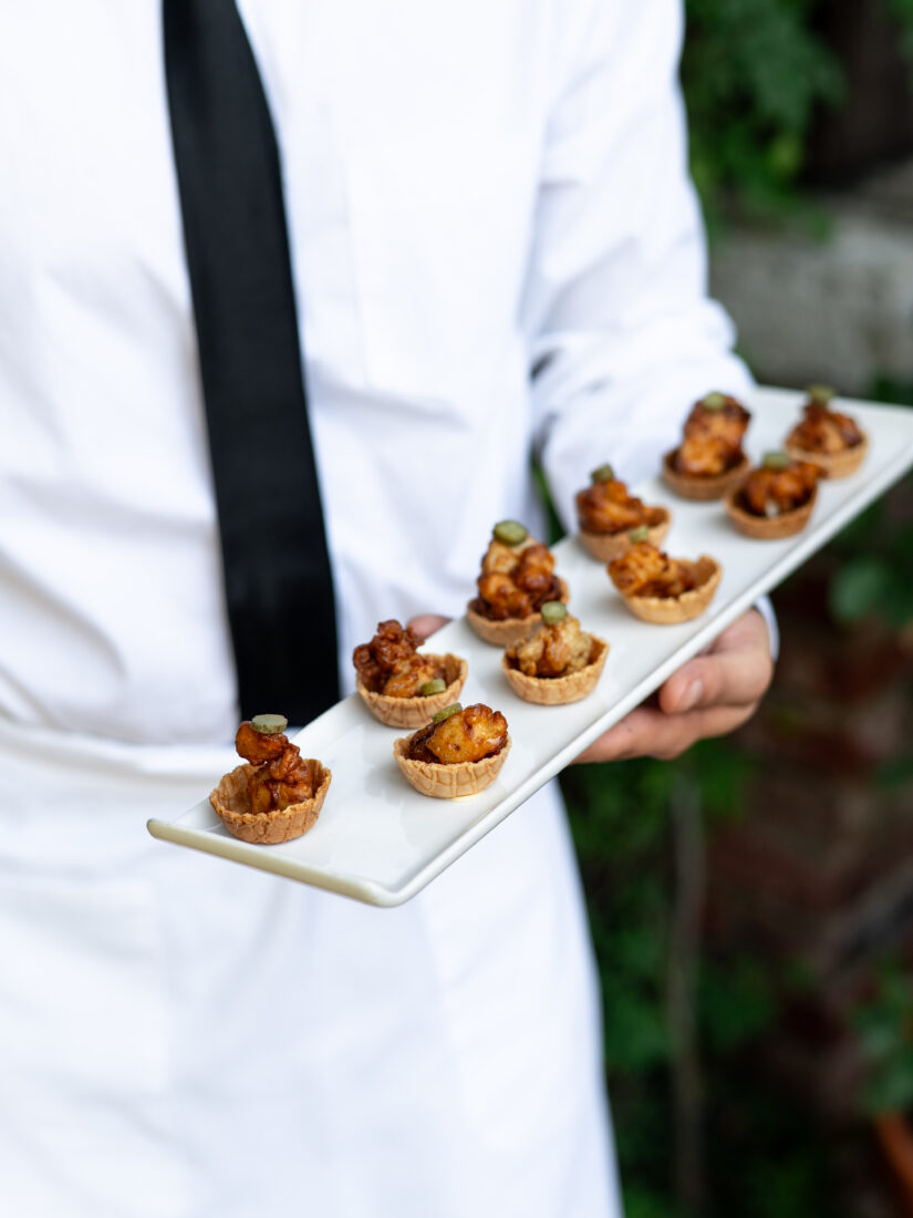Chicken and waffles with maple butter and cornichons.