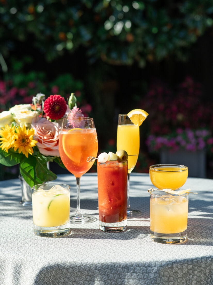 An assortment of brunch cocktails (from left): the Photo Finish, made with passion fruit liqueur, vodka, lime, lemon, and soda; the Trackside Spritz, comprised of Aperol, sparkling wine, club soda, strawberry, and fresh citrus; the Starting Gate, a blend of Castle & Key Sacred Spring vodka, fresh tomato juice, spices, celery, olive, and lemon; the Morning Mile with sparkling wine and fresh squeezed orange juice; and the Long Gallop Home, comprised of Town Branch Bourbon, lemon, ginger, maple, and peach.