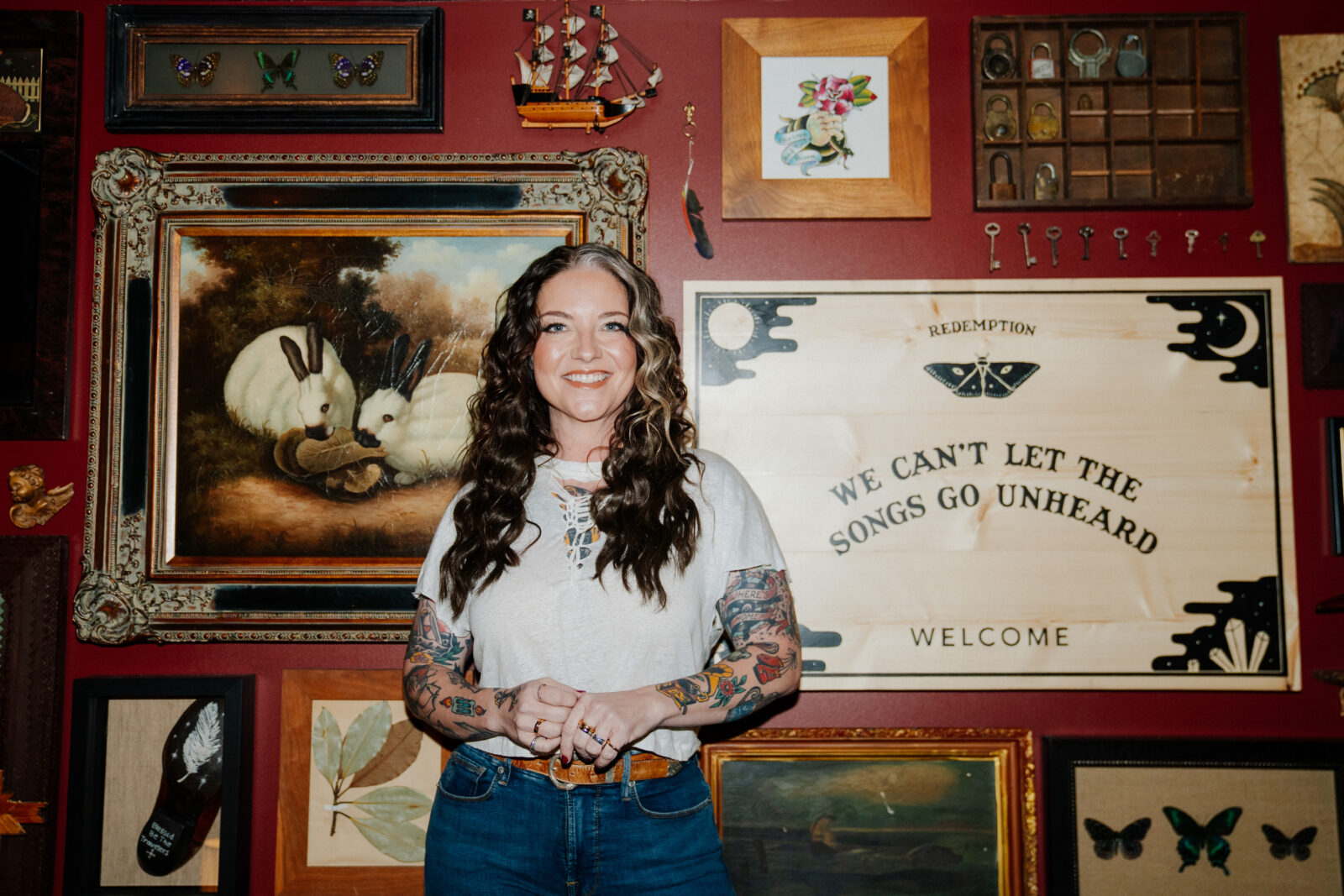 A portrait of a woman against a gallery wall
