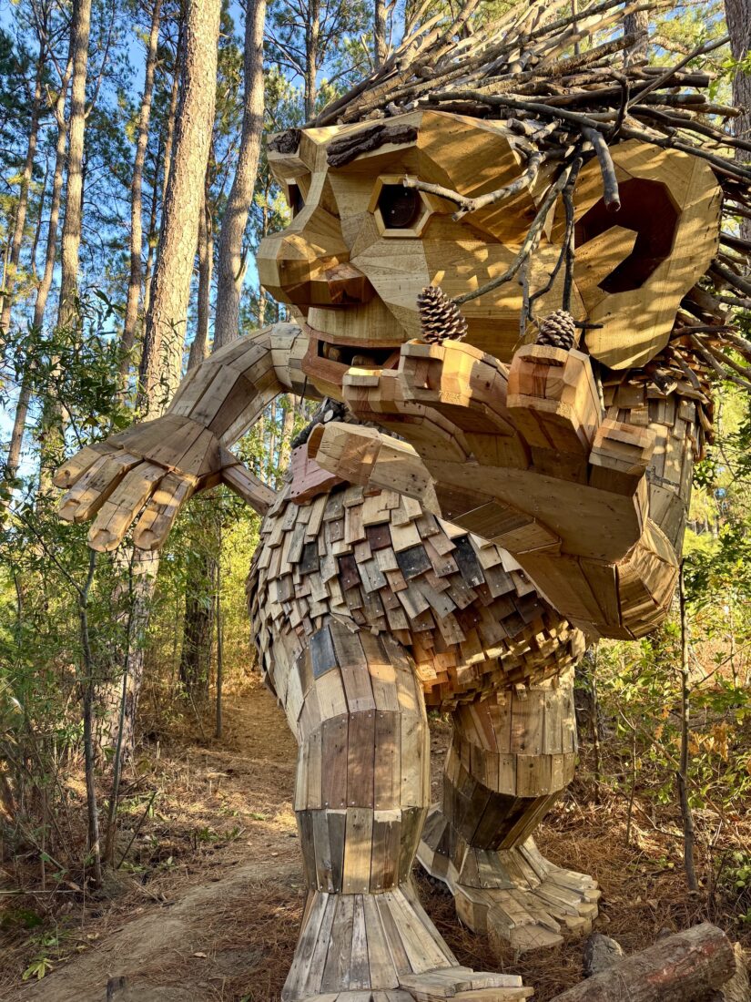 A large troll sculpture in a park