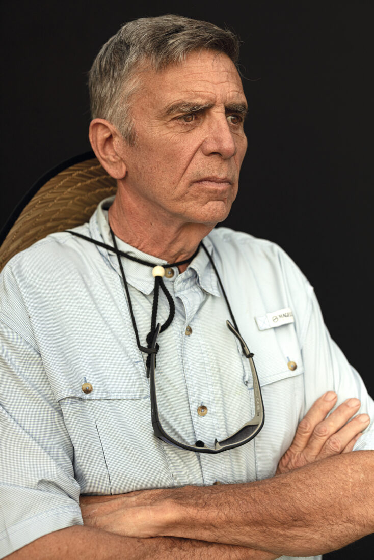 A portrait of a man against a black background