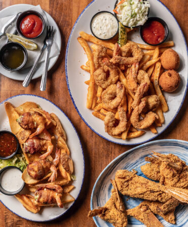 A fried shrimp platter, snapper wings, and a plate of “shrimp frogs”