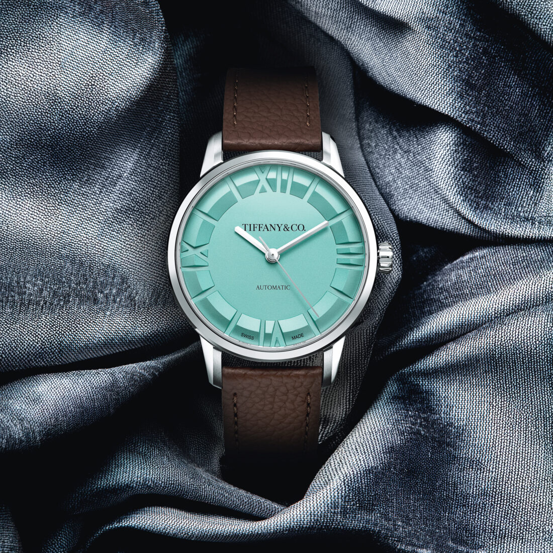 A watch with a teal face